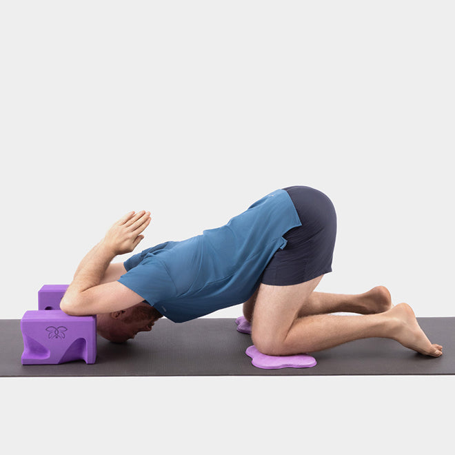 Melting Heart Pose (Uttana Shishosana) on yoga blocks
